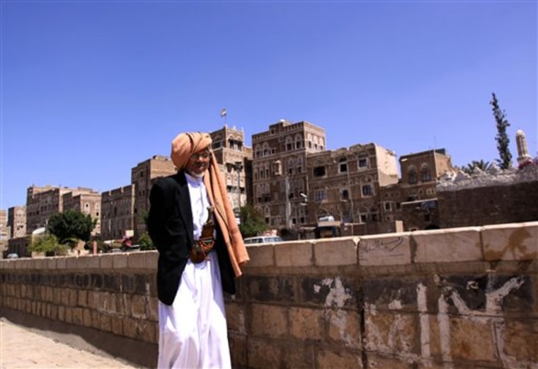 An unidentified Yemeni man walks near Saba Institute, an Arabic language school seen in background, in the Yemen capital of  San'a on Sunday. Al-Qaida in Yemen, suspected in the thwarted mail bombing attempt, appears to be aggressively seeking to recruit American and European radicals who could provide an entry way for the group to carry out attacks in their homelands.